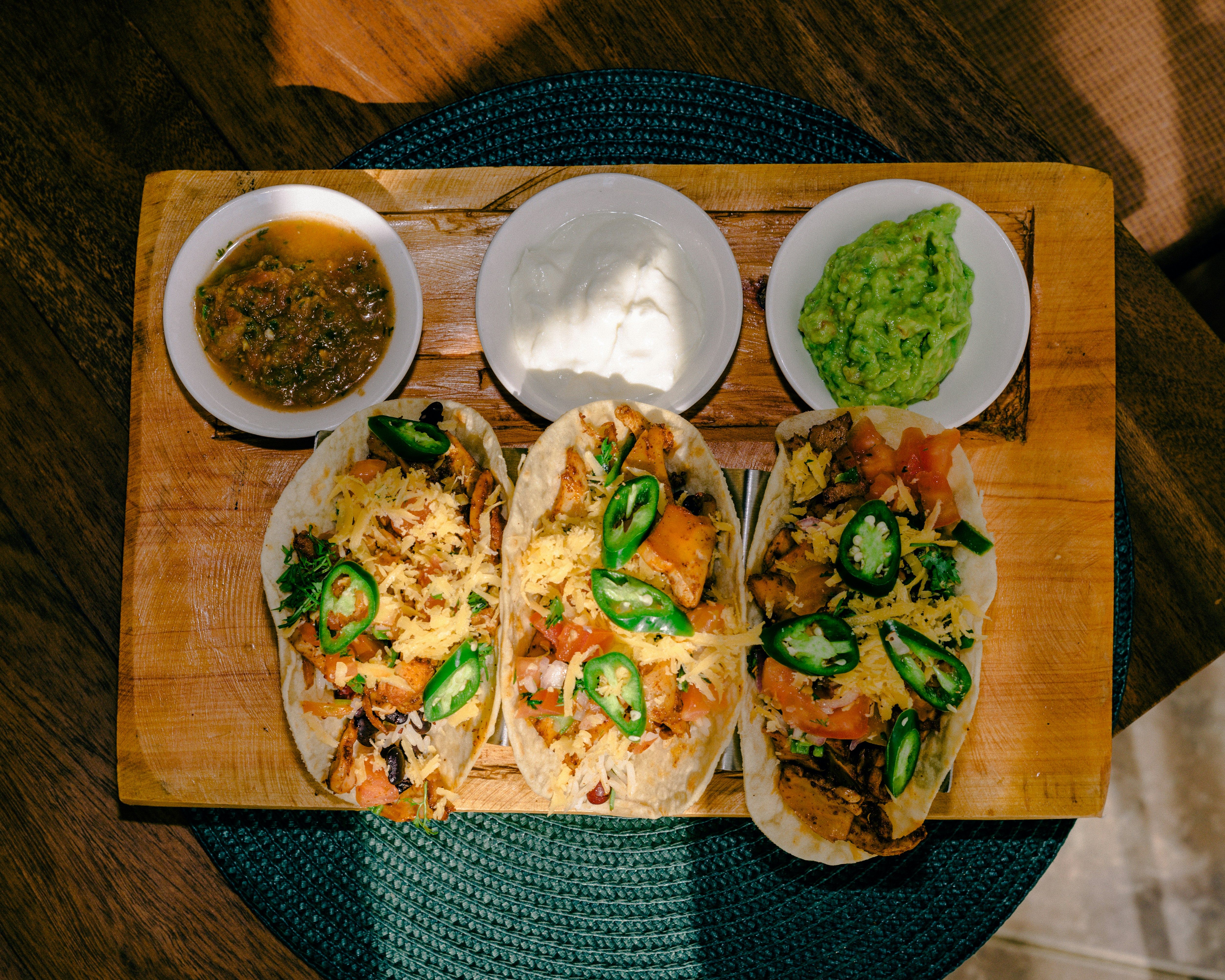 a large dish with six tacos